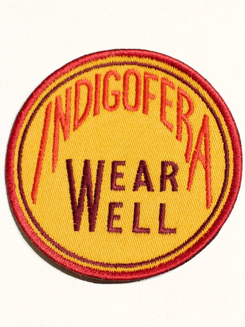Indigofera Wear well round badge